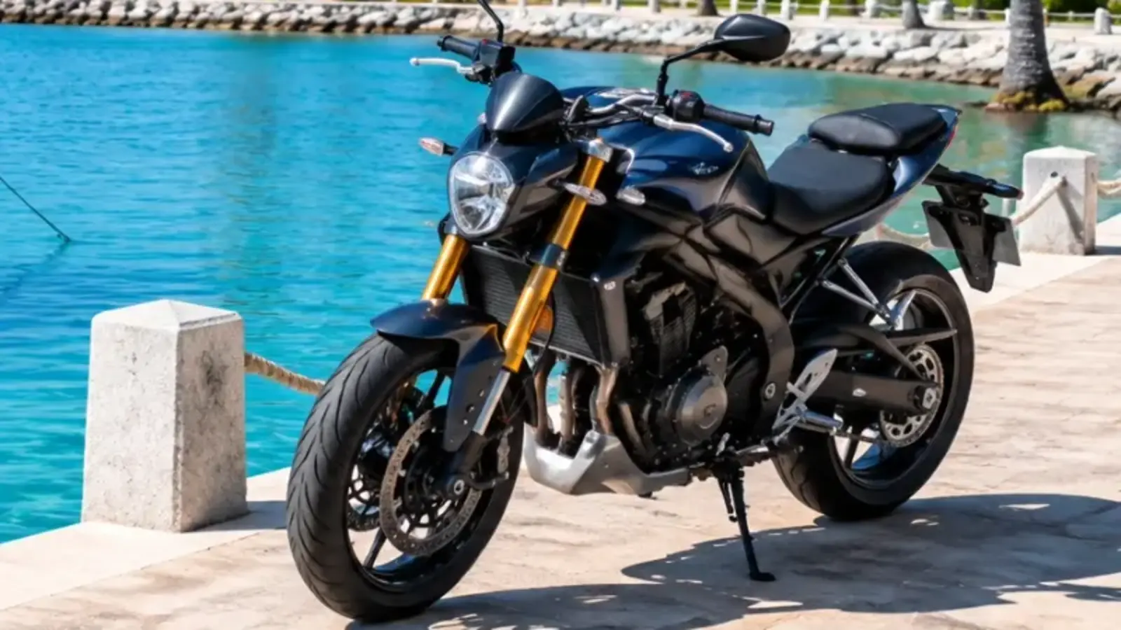 Black motorcycle parked beside Caribbean water for motorcycle insurance